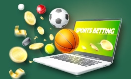 latop placed on desk with sports betting text displayed on screen and football and basketball balls and coins coming out of the screen